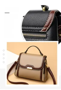 Detail of precise stitching, metal zipper, and khaki lychee grain leather on women's handbag