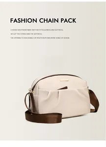 Detail of beige crossbody bag showing soft sheepskin texture and golden brand logo