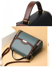 Close-up of stitching and metal hardware on a vintage pebbled leather boston bag