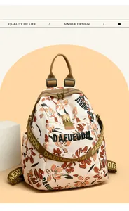 Detail of floral patterns and sturdy shoulder straps on the beige fashion backpack