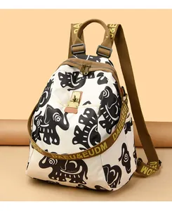 Detail of canvas backpack with ethnic elephant print and brown woven brand strap