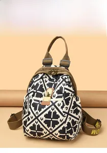 Detail of geometric pattern, metal buckle closure and side pockets on a compact backpack