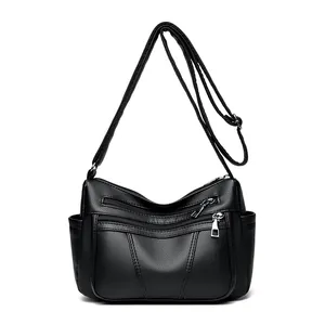 Black pebbled leather crossbody bag with multiple zip pockets and adjustable strap