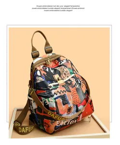 Close-up of graffiti print backpack with metal buckle and DAFU lettered webbing strap