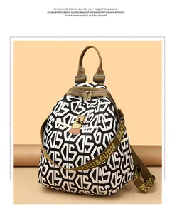 Detail view of printed canvas backpack with adjustable straps and golden metal zippers