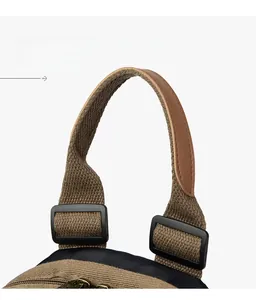 Macro detail of brown canvas travel bag with leather handle and plastic buckles