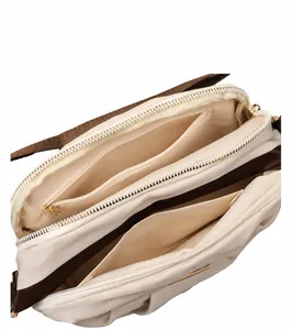 Detailed interior of nylon crossbody bag featuring multiple practical zipper compartments