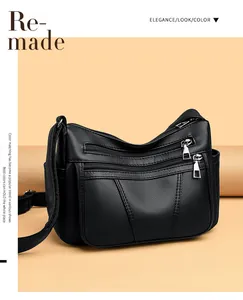 Detailaufnahme der schwarzen PU-Ledertasche mit Lychee-Textur und Metall-Reißverschlüssen