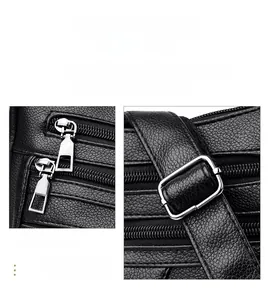 Close-up of black lychee texture leather bag with silver metal zipper and buckle details