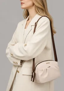 Close-up of beige crossbody bag featuring pleated oxford fabric and adjustable strap