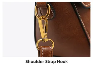 Detail of retro leather texture with white stitching and bronze shoulder strap hook
