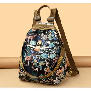 Primer plano de mochila de nailon con estampado de jungla tropical y correas con logo