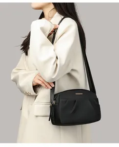 Crossbody bag for women in black nylon with gold logo and pleated texture detail