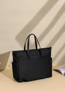 Business laptop bag with water-resistant nylon texture and side pocket in sunlit office