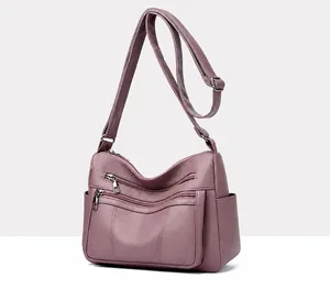 Detailed view of purple lychee pattern faux leather handbag with triple zipper pockets