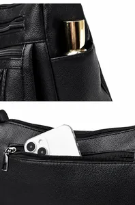 Detalle del bolsillo lateral y del compartimento con cremallera trasera del bolso de cuero