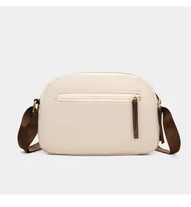 Detail view of the waterproof oxford crossbody bag back pocket with metal zipper