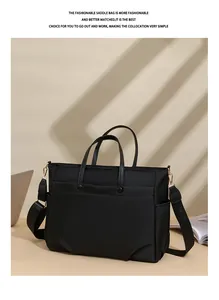 Detail of a large black laptop tote with gold hardware and detachable shoulder strap