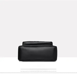 Detail shot of black pebbled leather handbag bottom with reinforced stitching and clean seams