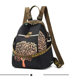 Macro side view of fashion backpack with colorful tree print and golden metal clasp