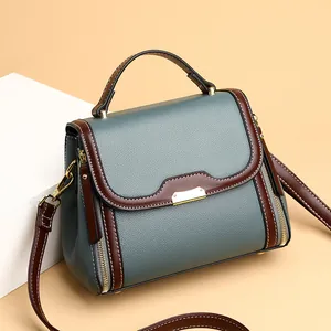 Elegant retro grey-blue handbag for women with brown trim and golden hardware