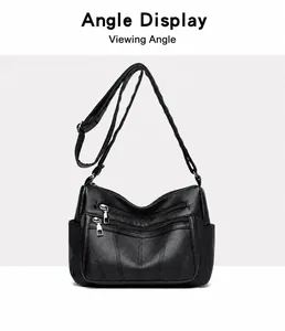 Front view of black pebble leather tote bag with dual zipper pockets and wide strap