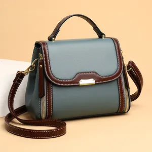 Vintage gray-blue faux leather crossbody bag with brown trim and metallic details