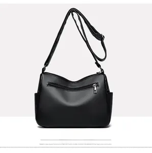 Rear view of black lychee texture leather crossbody bag showing back zipper pocket