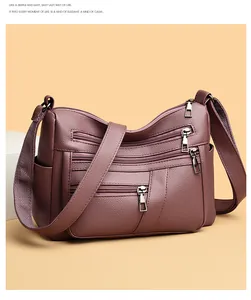 Detailed texture of burgundy soft faux leather crossbody bag with multiple zippers