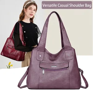 Detail view of large capacity multi-layer purple leather handbag with textured finish