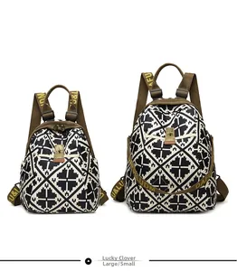 Comparison of large and small geometric clover pattern backpacks with metal twist locks