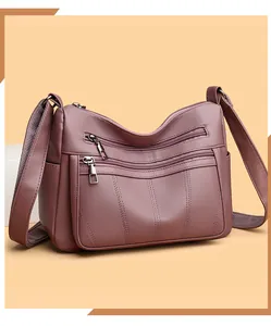 Close-up of dark purple tote bag with lychee texture and multi-layer zippers detail