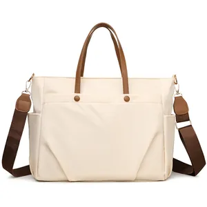 Off-white large capacity laptop tote bag with brown leather handles and wide crossbody strap