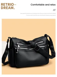 Détail du sac bandoulière en cuir grainé noir avec plusieurs poches zippées et sangle large