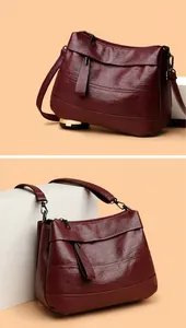 Details von Leder-Umhängetaschen mit Reißverschlüssen in Burgund und Caramel