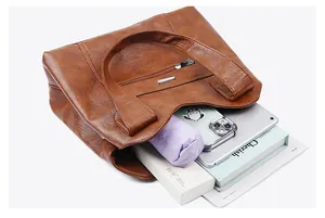 Macro shot of large capacity dark brown leather tote bag showing spacious interior space