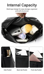 Detalle de los múltiples compartimentos del bolso bandolera de cuero negro de gran capacidad
