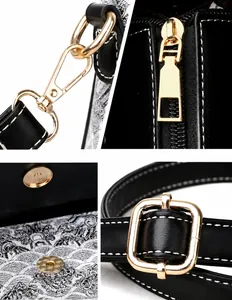 Detailopname van gouden hardware, ritsen en witte contraststiksels op de zwarte leren handtas