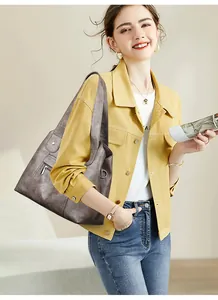 Close-up of soft leather texture and silver zipper detail on large vintage tote bag