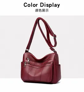 Macro detail of wine red tote bag with lychee pattern leather and metal zippers