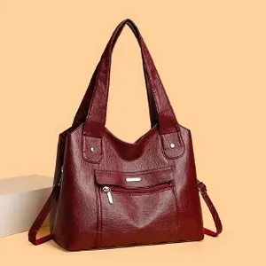 Burgundy faux leather tote bag with pebble texture and adjustable shoulder strap for women