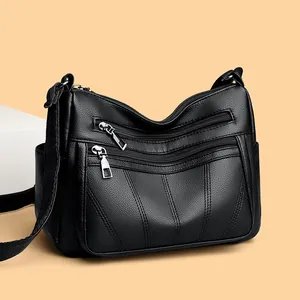 Classic black tote bag with multi-zipper compartments and textured leather finish