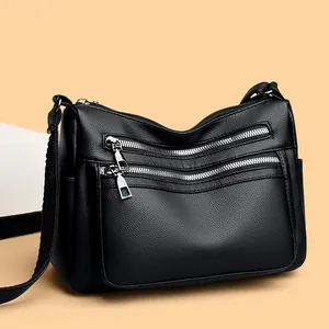 Sac bandoulière classique en cuir souple noir avec plusieurs fermetures éclair argentées