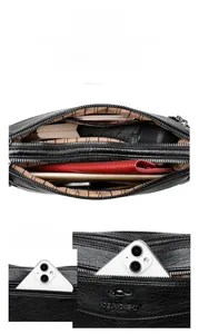 Detailed view of the black leather shoulder bag with multiple compartments and large capacity