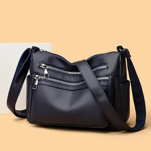 Sac bandoulière bleu marine multi-poches en cuir souple avec fermetures éclair argentées