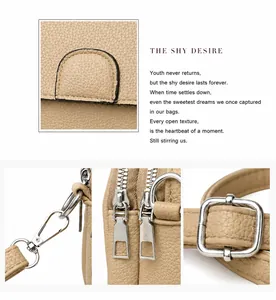 Detail of lychee pattern leather mini round bag with double zippers and metal hardware