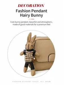 Detail of knitted rabbit charm with houndstooth outfit on a beige lychee leather handbag