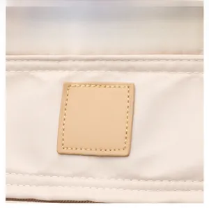 Detail shot of twill nylon fabric and synthetic leather patch on a large tote bag