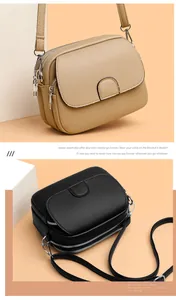 Detail of beige and black crossbody bags showing textured lychee leather and multi-zip compartments