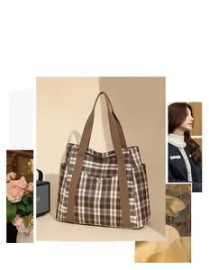 Detail of checkered tote bag with brown fabric straps and metal snap button pocket